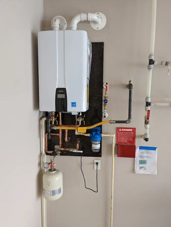 Professional plumber installing copper piping in a Coventry home